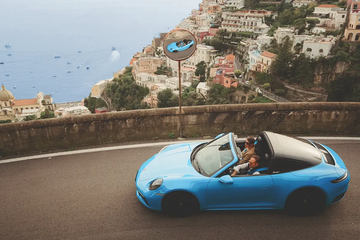 Porsche 911 on a scenic road along the Amalfi Coast.