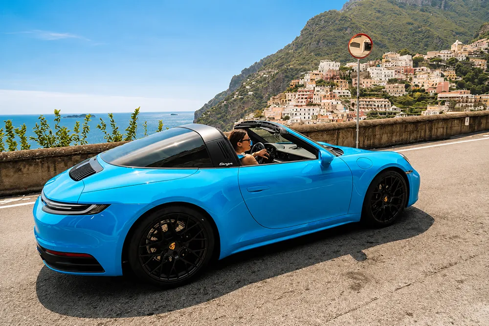 Porsche on a scenic road along the Amalfi Coast.