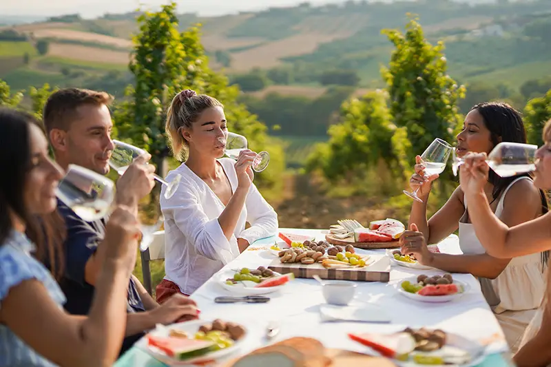 Group of friends enjoying a wine tasting at a local winery.
